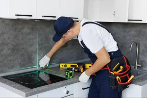 Expert installation of a granite slab by a certified technician, highlighting the precision required for sink cutouts and perfect fit.